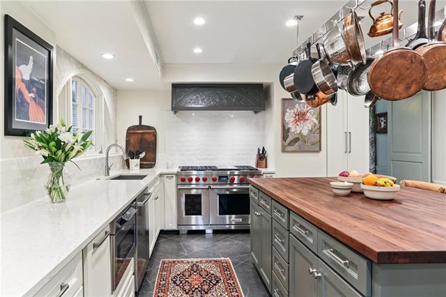 Renovated chef's kitchen with marble counters and pro range in a historic Audubon, New Orleans home