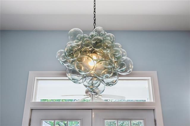 Hand-blown glass bubble chandelier over French doors in a renovated Navarre, New Orleans home